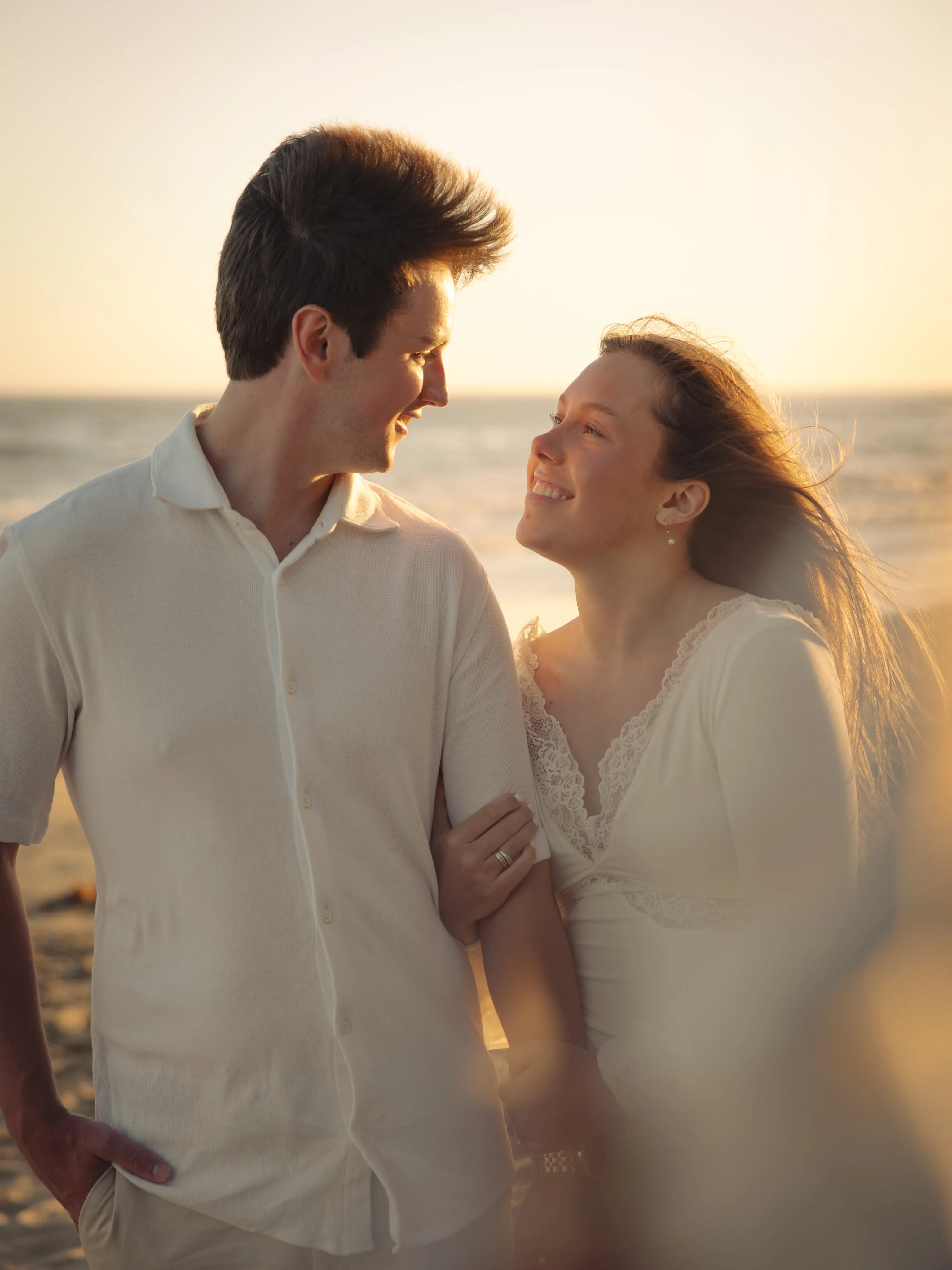 Couple in warm golden hour light on the Santa Barbara coast