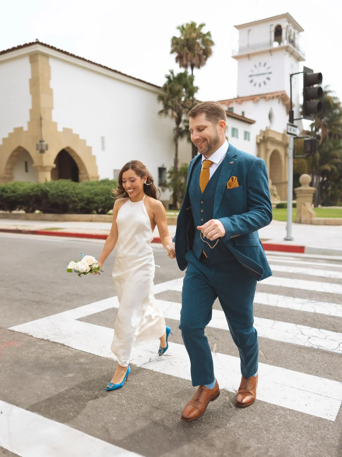 Newlyweds crossing the street in downtown Santa Barbara