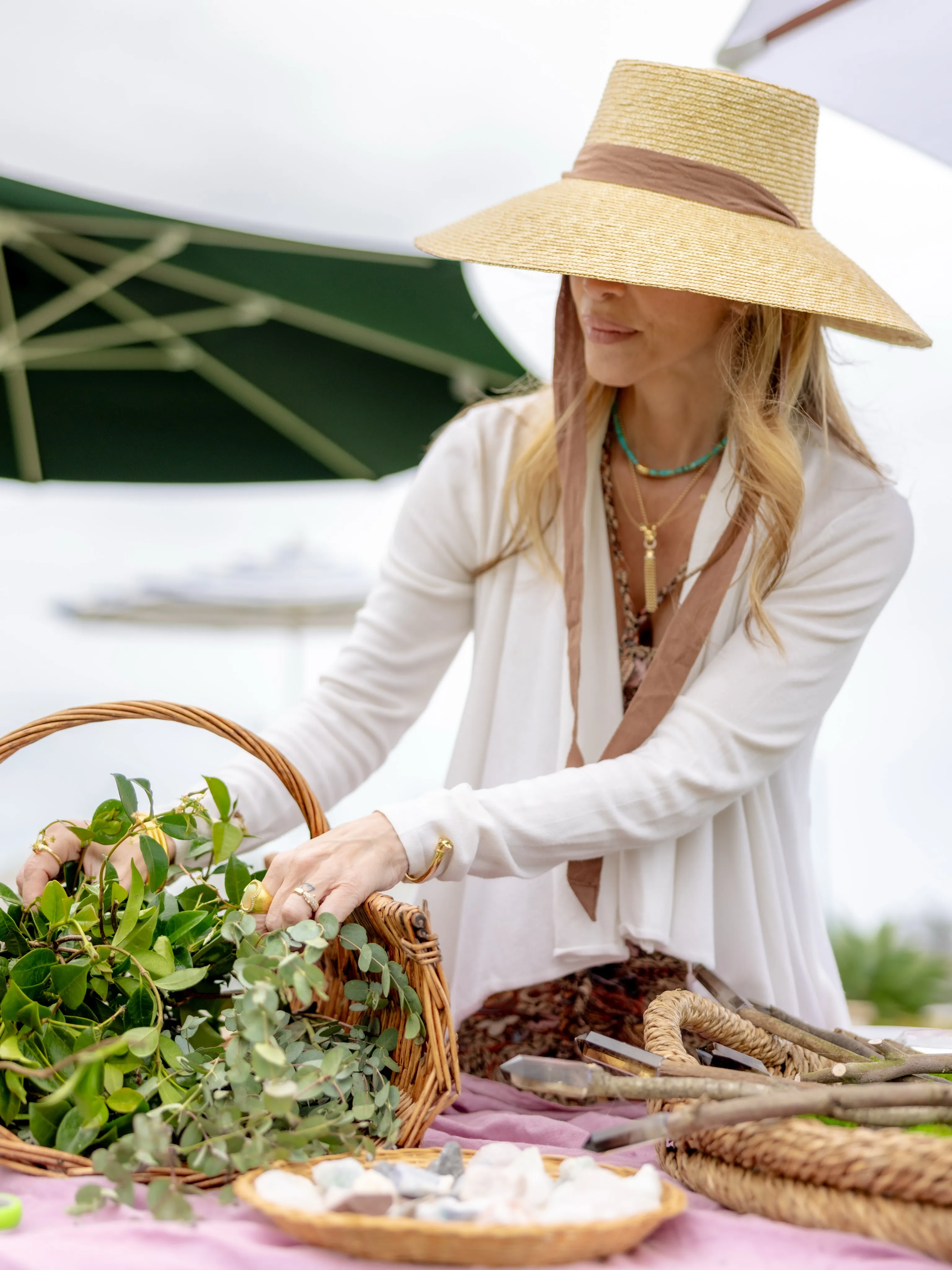 Host arranging greenery and favours on a party table