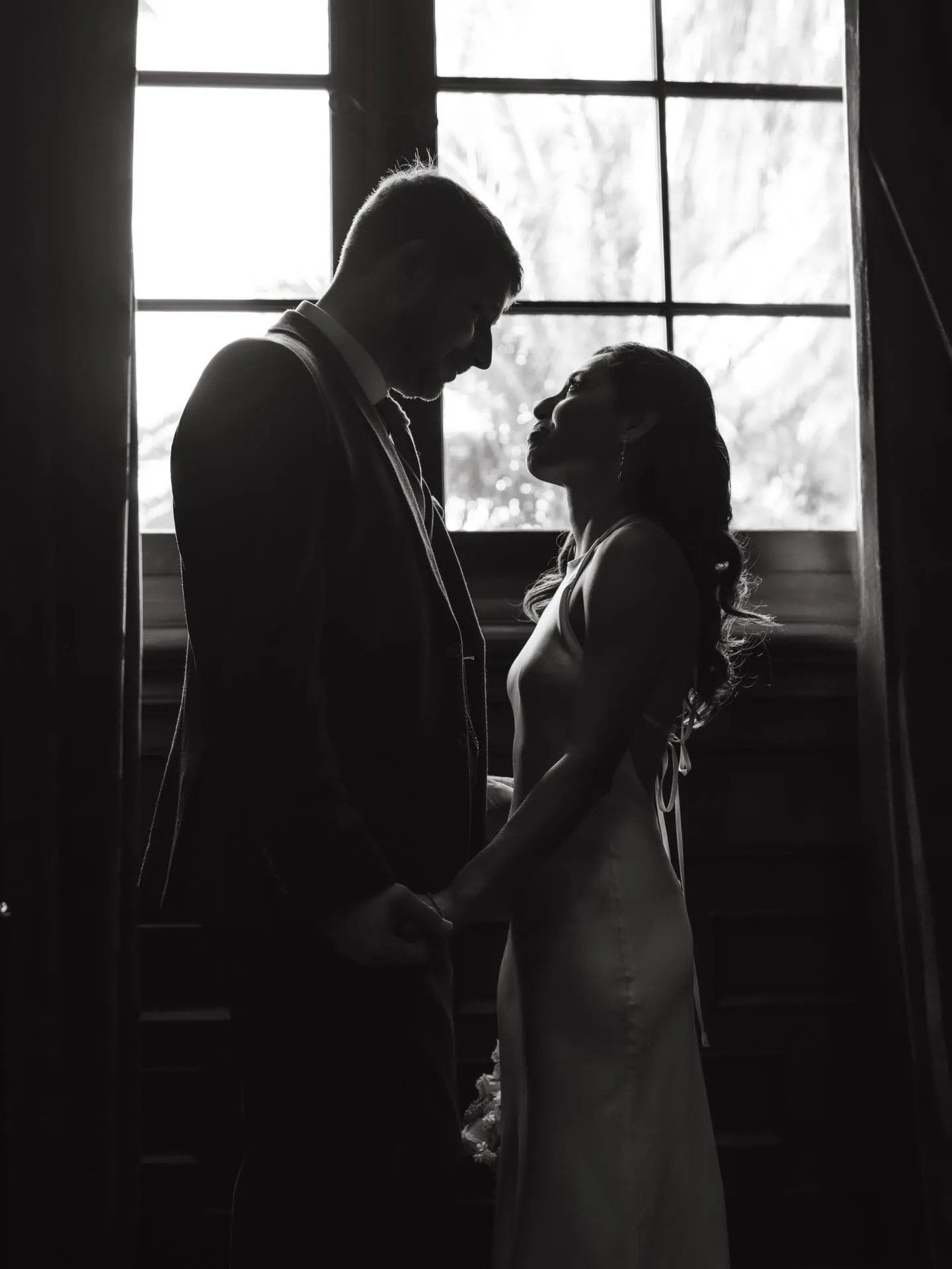 Silhouette of a couple in a tall window